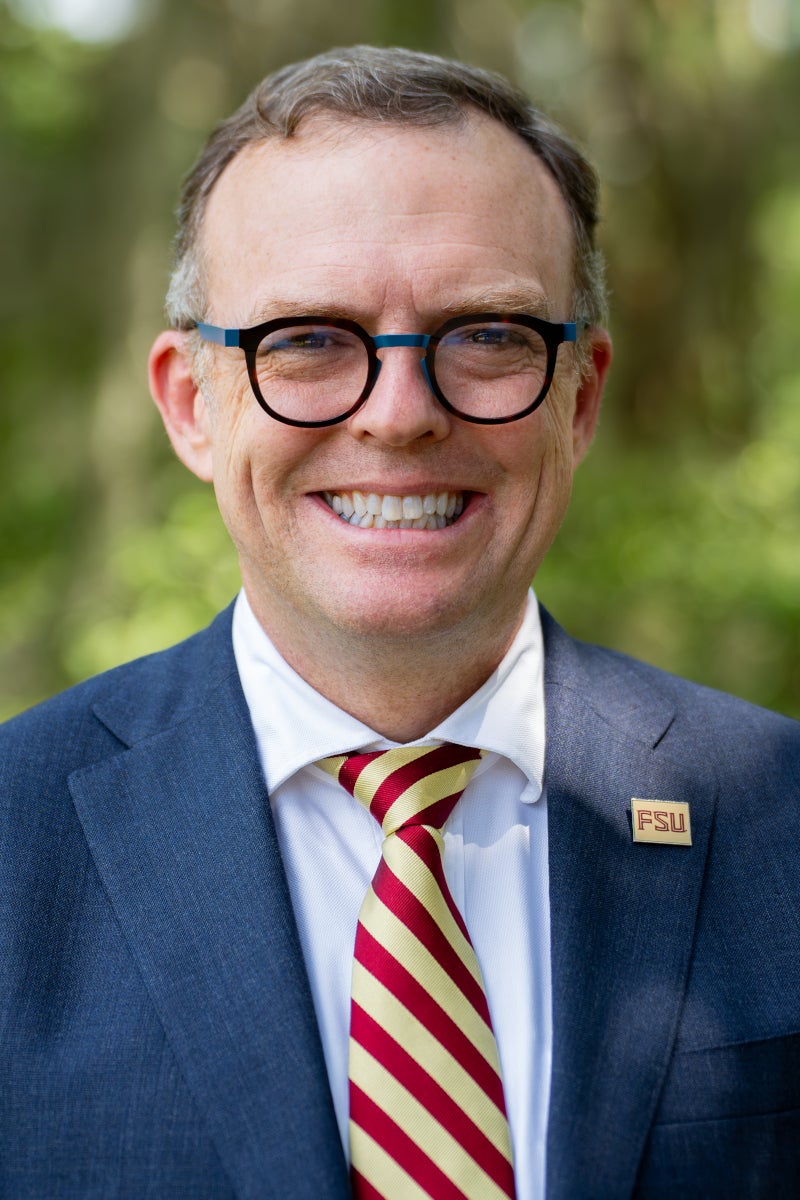 Headshot of the new FSU Dean of The Graduate School, Gregory Bell, wearing glasses in a suit jacket.